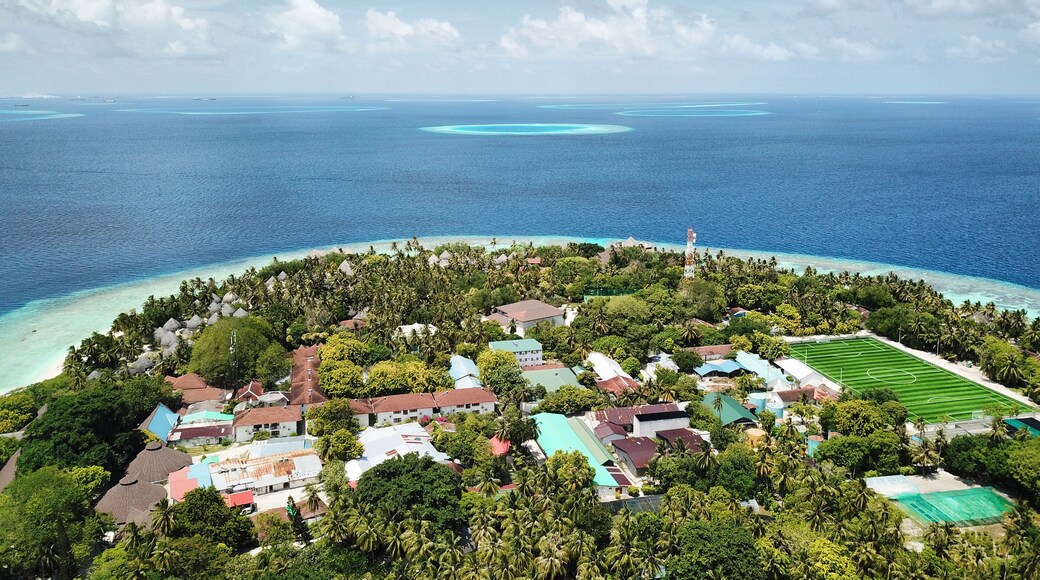 Maldives: Aerial View of Tropical Island Resort, with Private Beach, Palm Trees, Turquoise Sea, Blue Sky and Dramatic Clouds (Bandos Maldives, North Male Atoll, Indian Ocean) DJI Mavic Pro Drone
