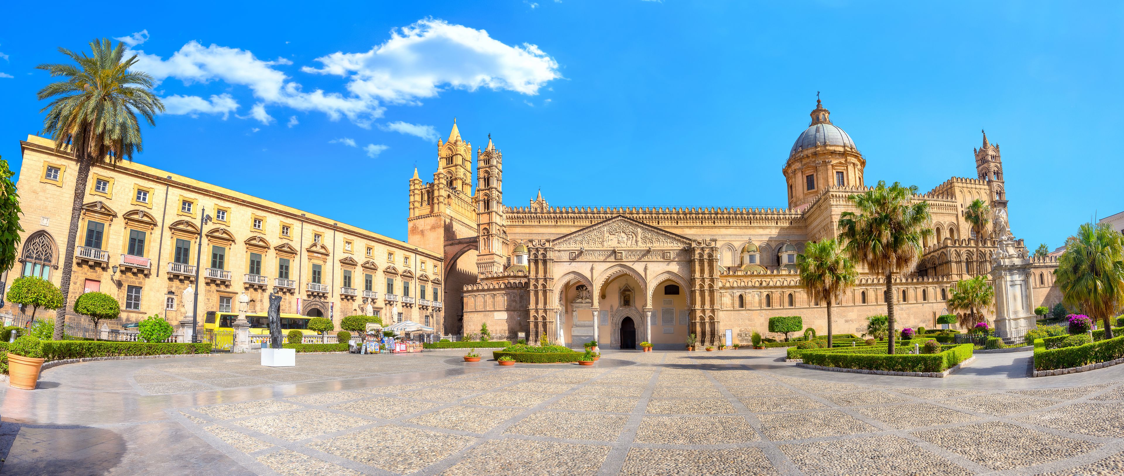 A historic plaza with a large cathedral featuring a prominent dome and intricate architecture.