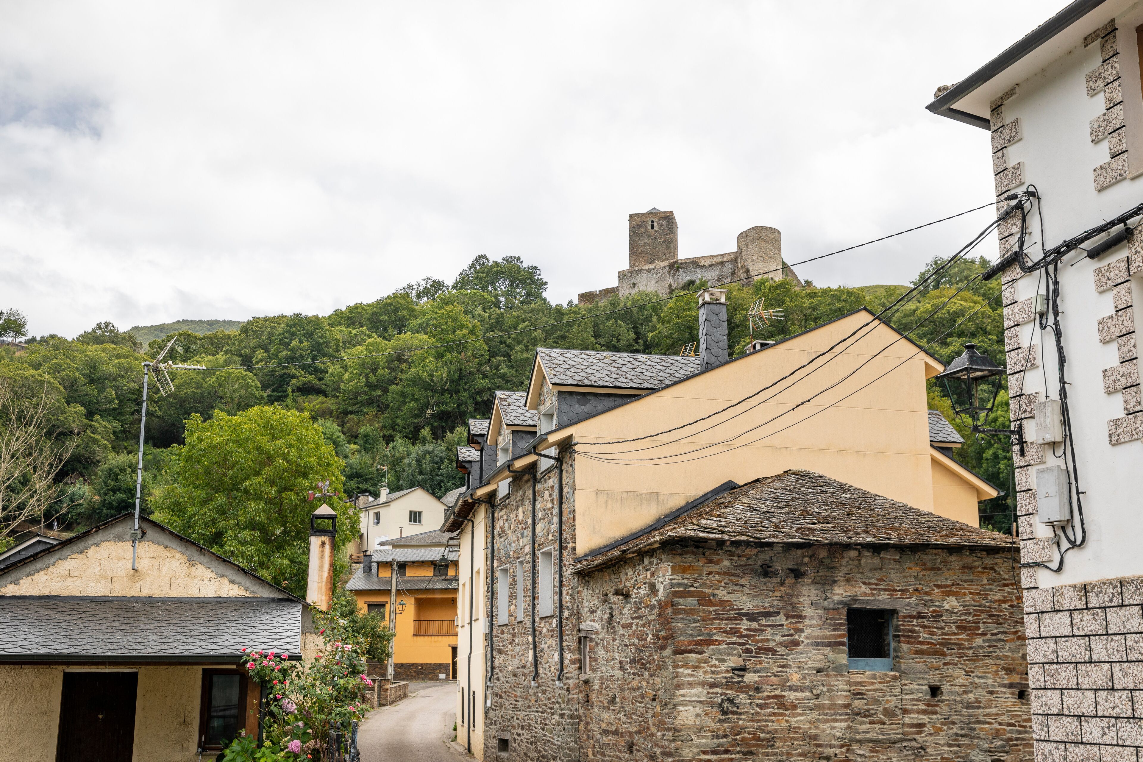 a street with a view to the castle in Balboa village, comarca of Valcarce, El Bierzo, province of Leon, Castile and Leon, Spain
