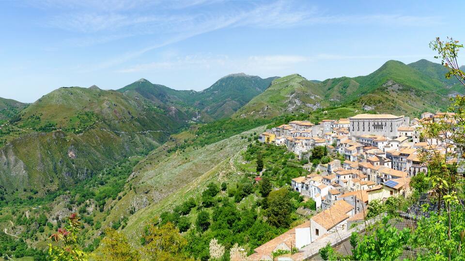 A mountainous landscape with a village nestled among the hills.