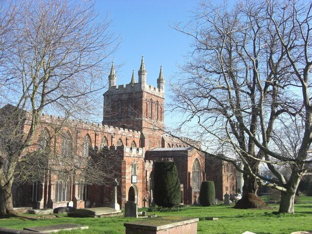 A historic church with a tall tower and arched windows.