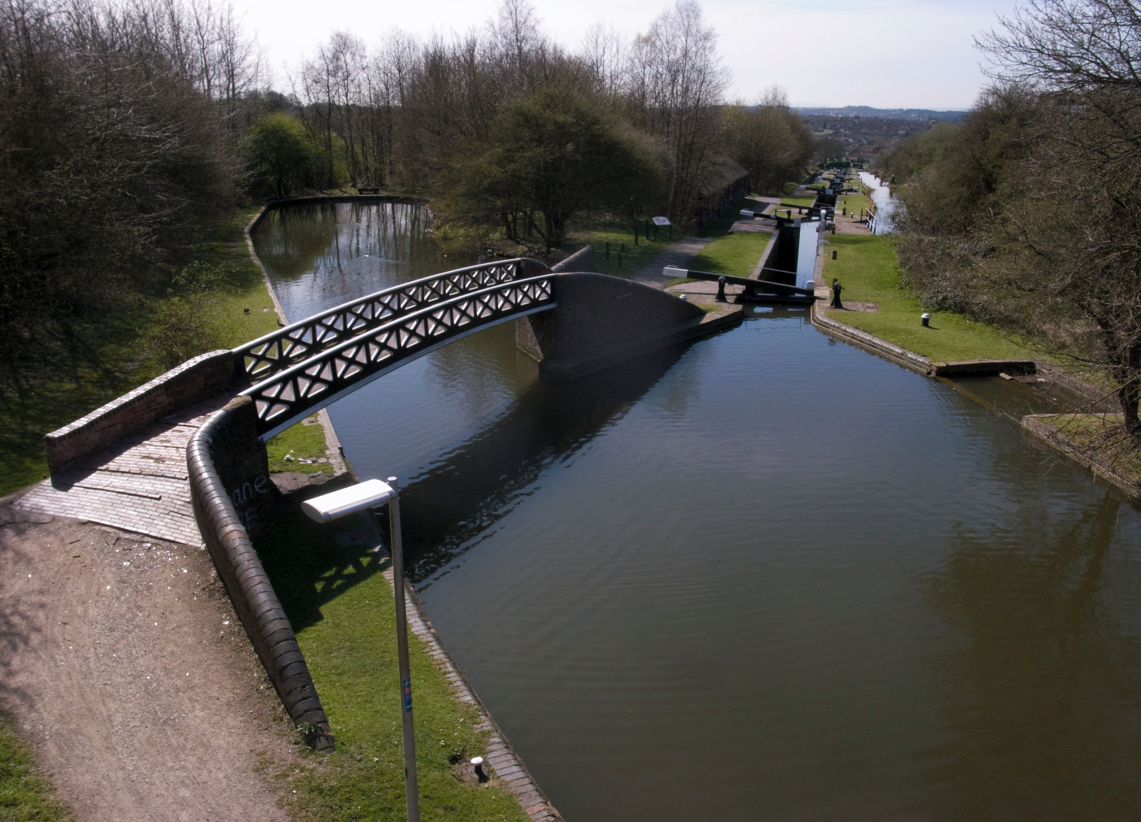 Delph Locks on the No. 1 Dudley Canal, England. This is No. 2 lock with side pound and a Horseley Ironworks bridge.