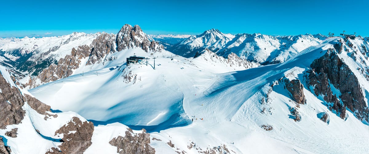 A snow-covered mountain range with a glacier.