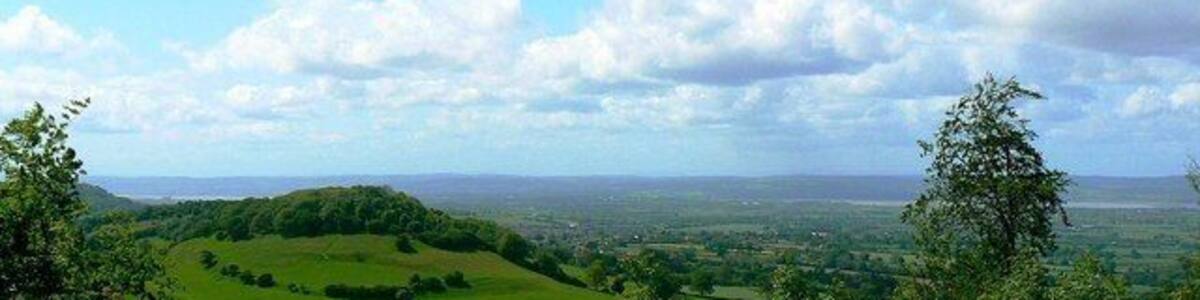 A view near Uley towards the Severn The landform at the left of the image is Cam Long Down in the next square west. To the right is the River Severn and beyond that the Forest of Dean.