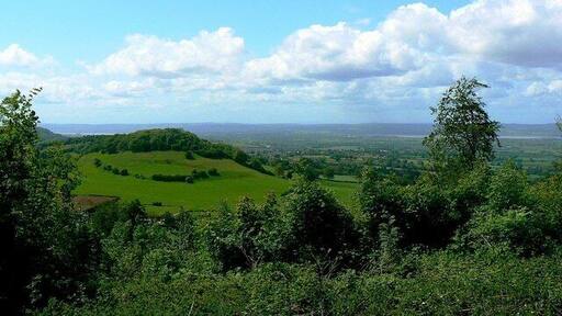 A view near Uley towards the Severn The landform at the left of the image is Cam Long Down in the next square west. To the right is the River Severn and beyond that the Forest of Dean.