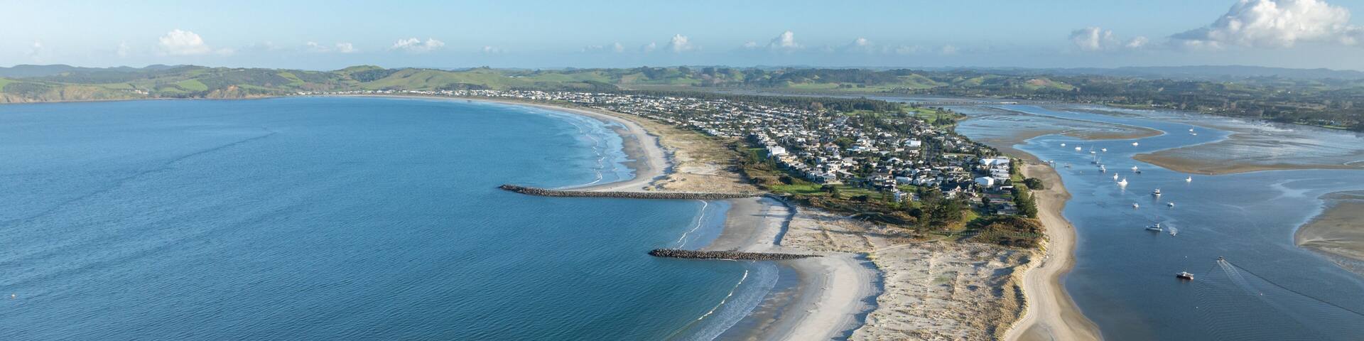 Aerial: Harbour and sandspit in Omaha Beach, Warkworth, New Zealand.