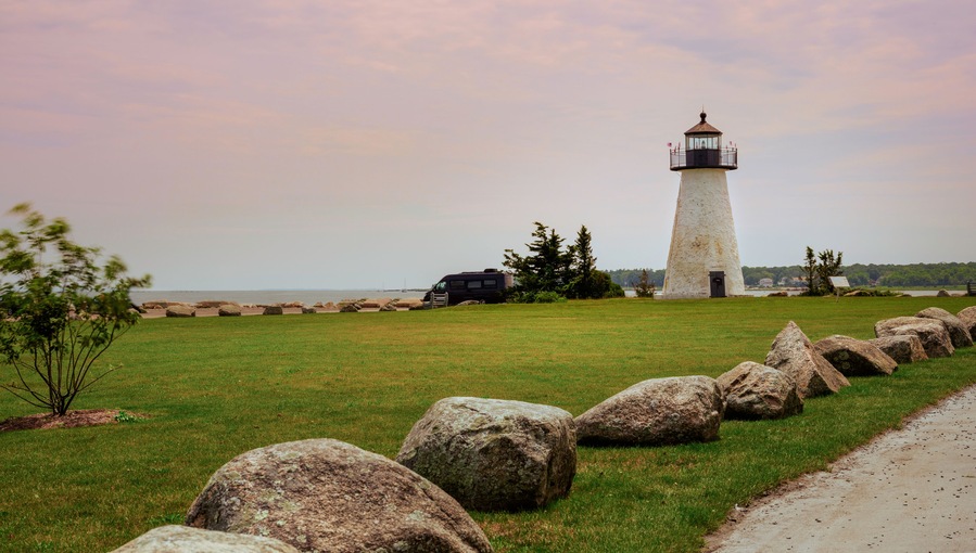 Neds Point Lighthouse with Rocks on the Road Side in Mattapoisett, Massachusetts. Historic Landmark Navigational Architecture Built in 1838.