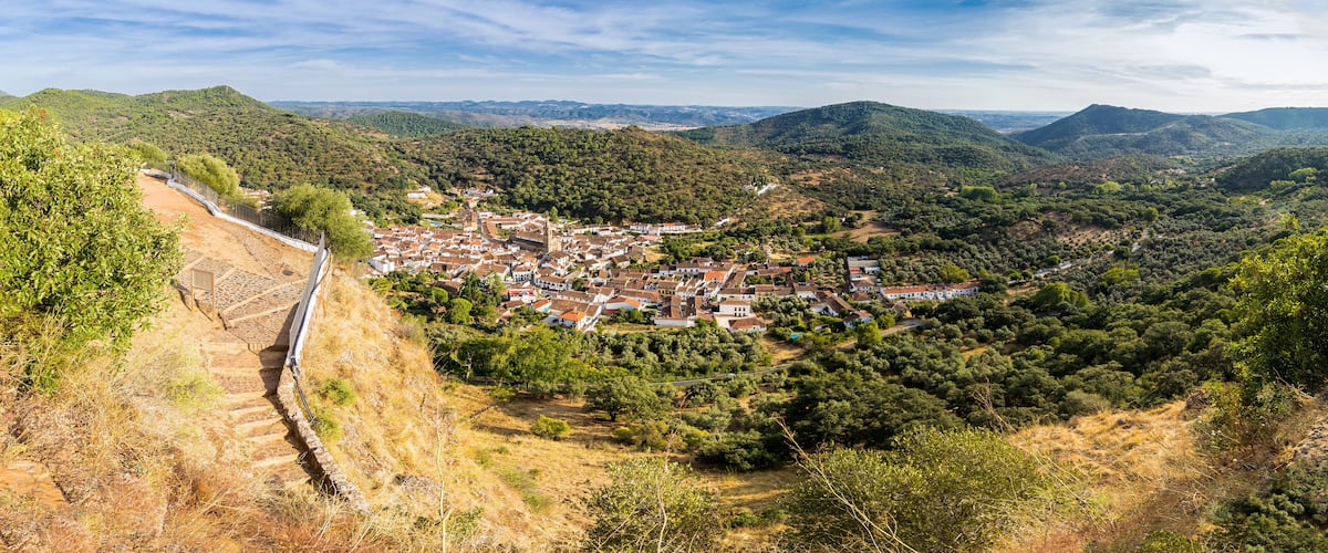 A town nestled in a valley surrounded by hills.