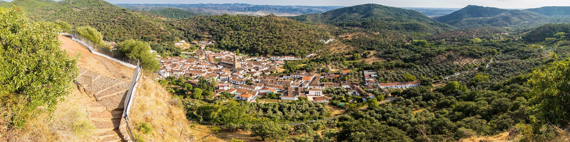 A town nestled in a valley surrounded by hills.