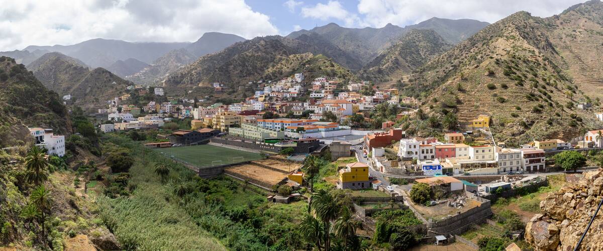 A mountainous town with colorful buildings nestled in the valley.