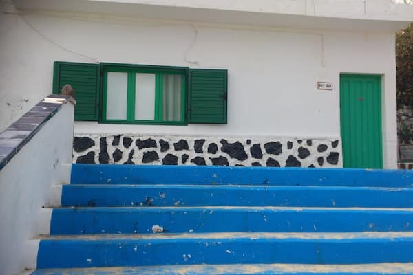 One of the oldest houses in Corralejo, I can't remember if it is the actual oldest or just next door to the oldest, but it is an original fisherman's cottage in typical Canarian style with an interior patio - the patio is between the main house and the bedrooms instead of at the front or rear of the house.
And just down those steps ...is the beach, la playa de ninas. Small soft sand beach and calm waters perfect for children.