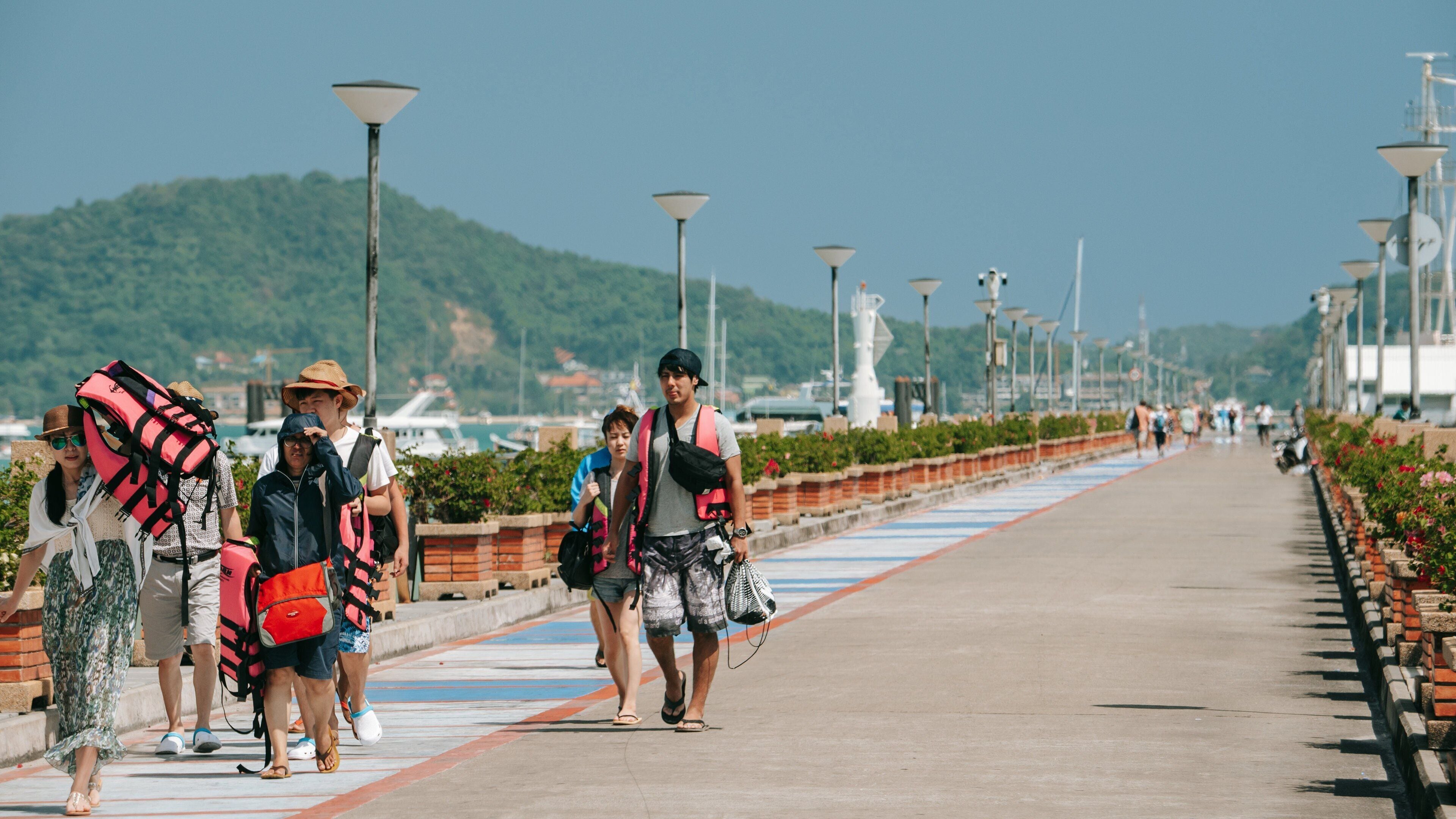 Chalong Pier featuring street scenes as well as a small group of people