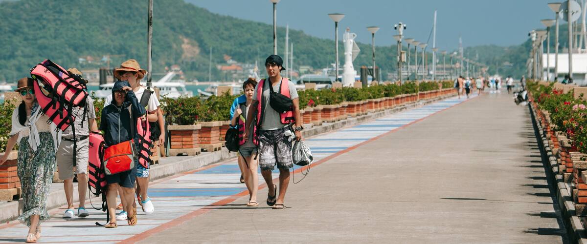 Chalong Pier featuring street scenes as well as a small group of people