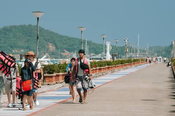 Chalong Pier featuring street scenes as well as a small group of people