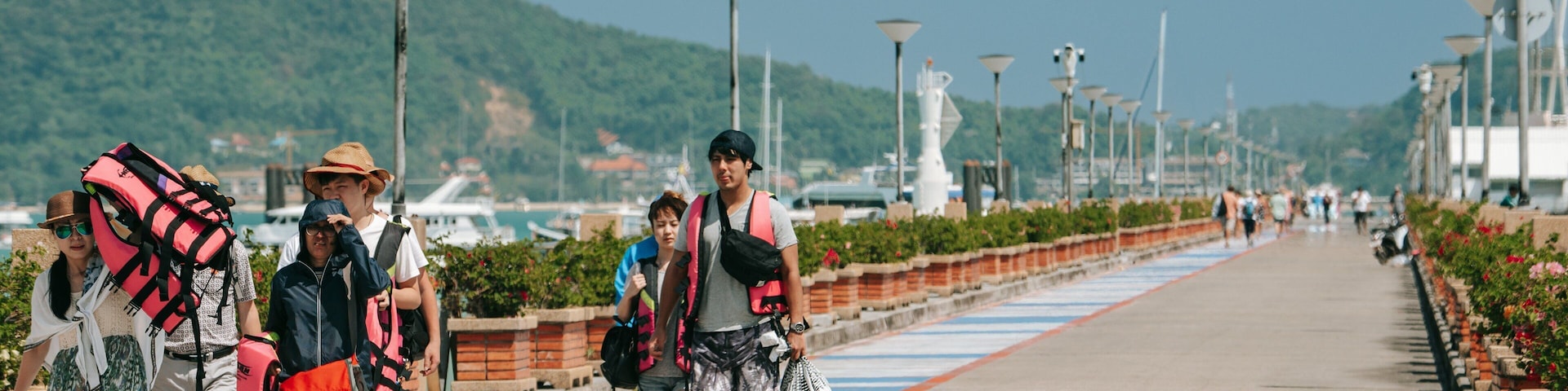 Chalong Pier featuring street scenes as well as a small group of people