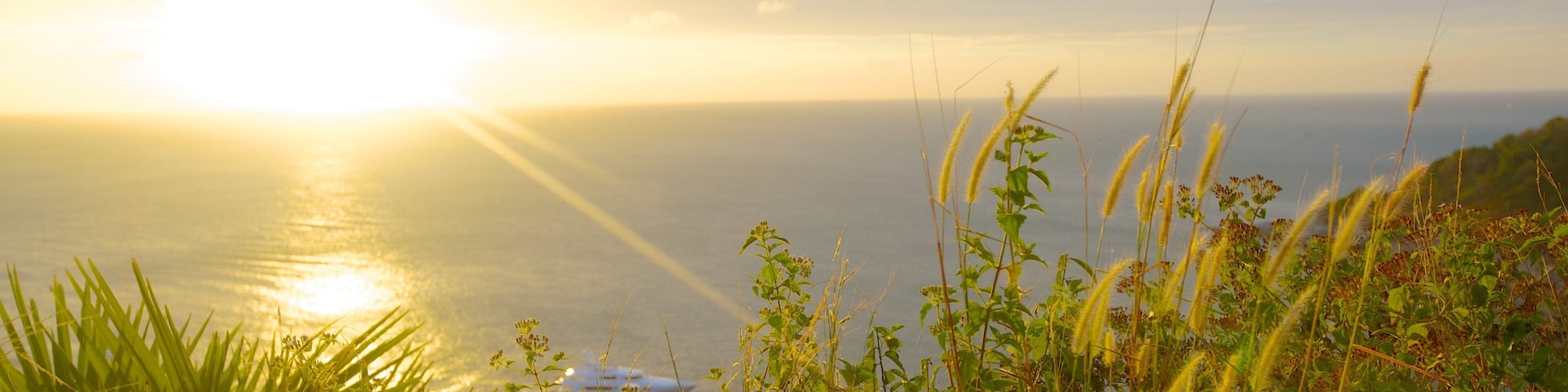 Promthep Cape which includes tropical scenes, a sunset and general coastal views