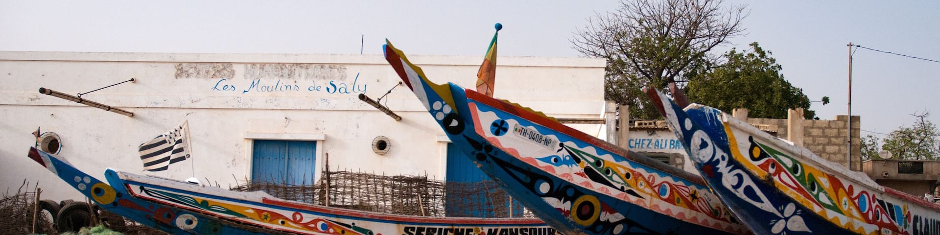 Mbour, Senegal: Colourful fishing boats stranded in the sand
