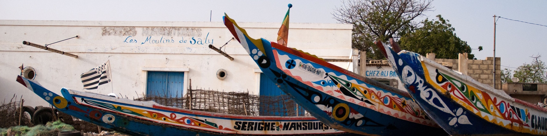 Mbour, Senegal: Colourful fishing boats stranded in the sand