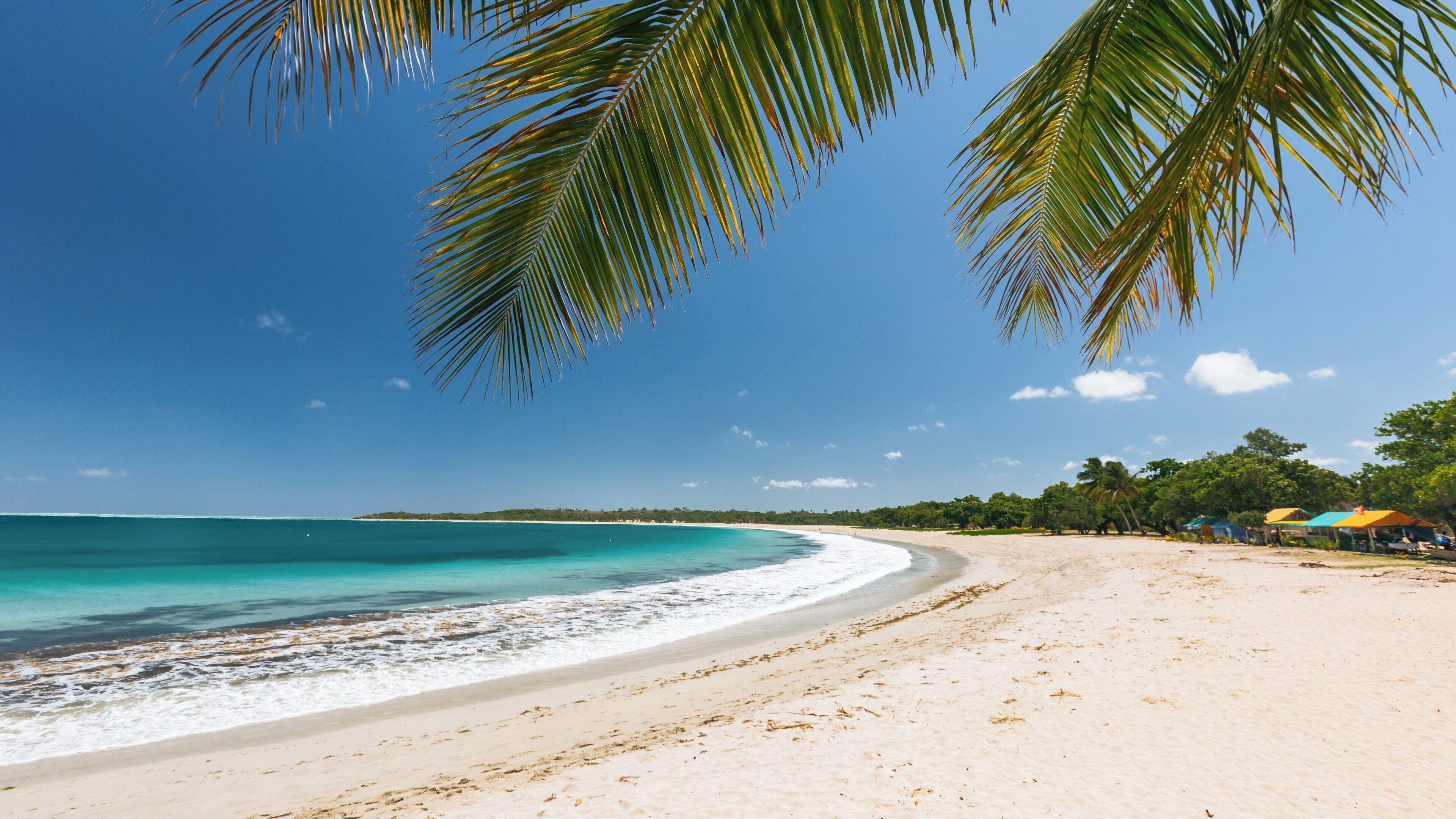 Stunning views of Natadola Beach showcasing pristine sand and turquoise waters in Fiji under a bright blue sky