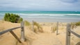 Warrnambool Beach which includes surf, a sandy beach and a bay or harbor