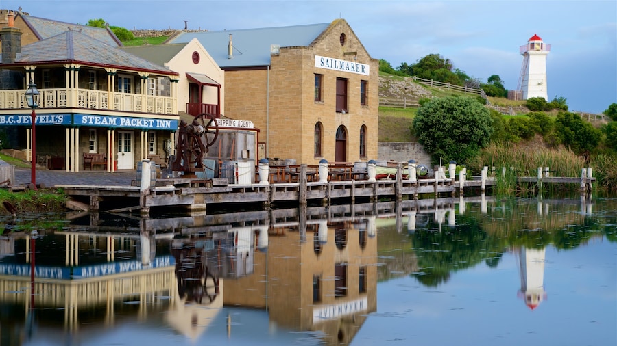 Flagstaff Hill Maritime Village which includes a lighthouse, signage and a bay or harbour