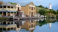 Flagstaff Hill Maritime Village showing a lighthouse, signage and a bay or harbor