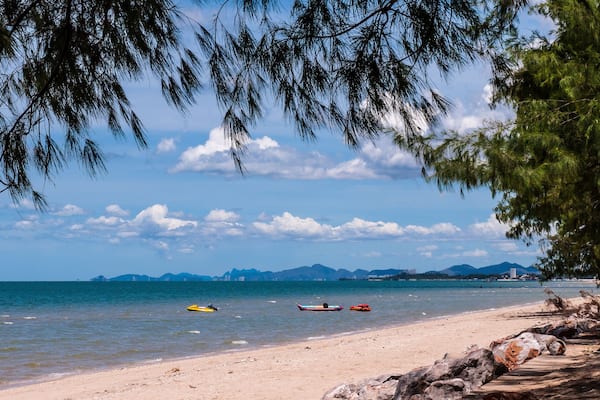 Beautiful Cha-am beach with blue sky and pine trees.