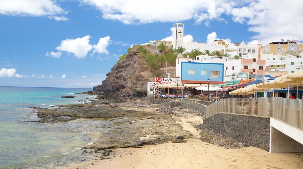 Morro Jable showing a sandy beach, rocky coastline and a coastal town