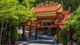 A traditional Vietnamese gate with ornate decorations and golden statues.
