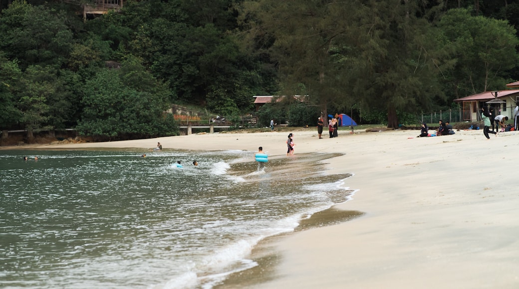 Perak, Malaysia - September 16, 2019: People at the beach of Teluk Batik. Teluk Batik Beach is located at Lumut and Sitiawan and looks out towards Pangkor Island, Perak's top beach destination.