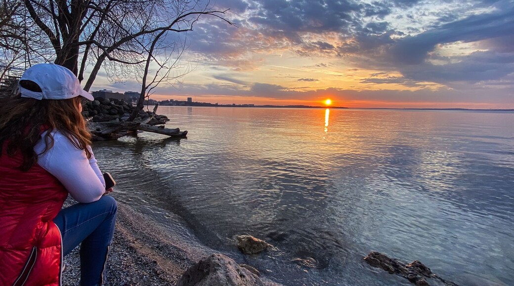 Woman Walking Along Lake Mendota at Sunset in Madison Wisconsin