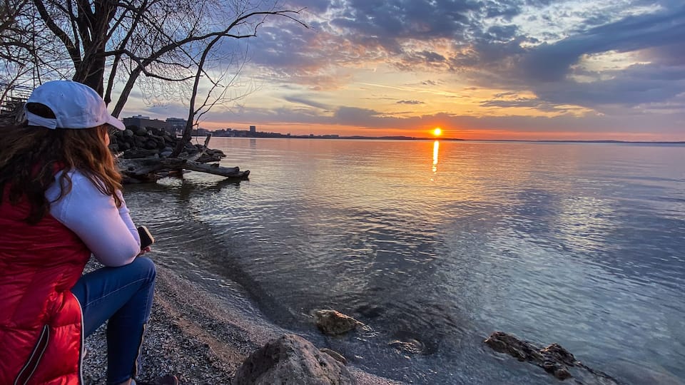 Woman Walking Along Lake Mendota at Sunset in Madison Wisconsin
