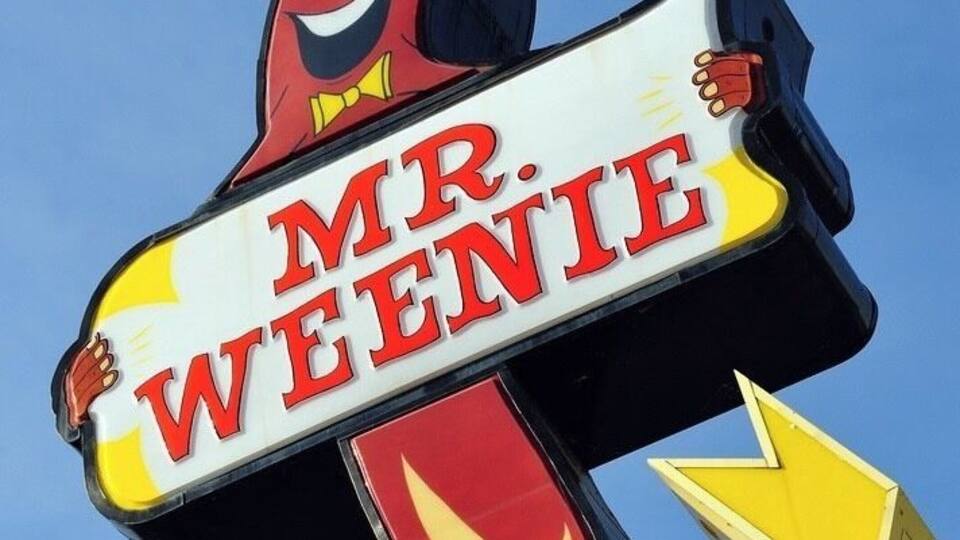 A Mr. Weenie sign with a cartoon character.