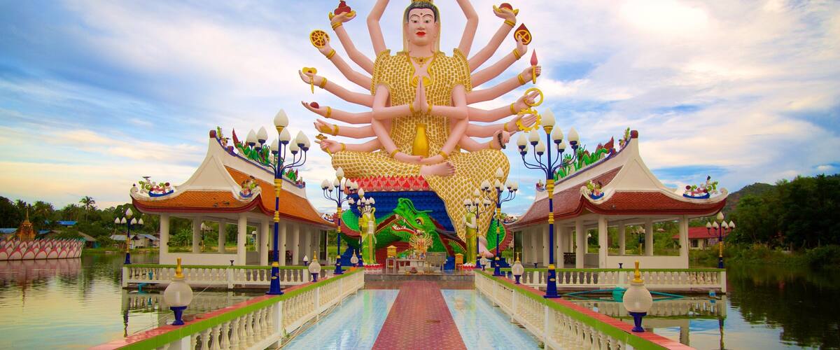 Wat Plai Laem which includes religious aspects and a statue or sculpture