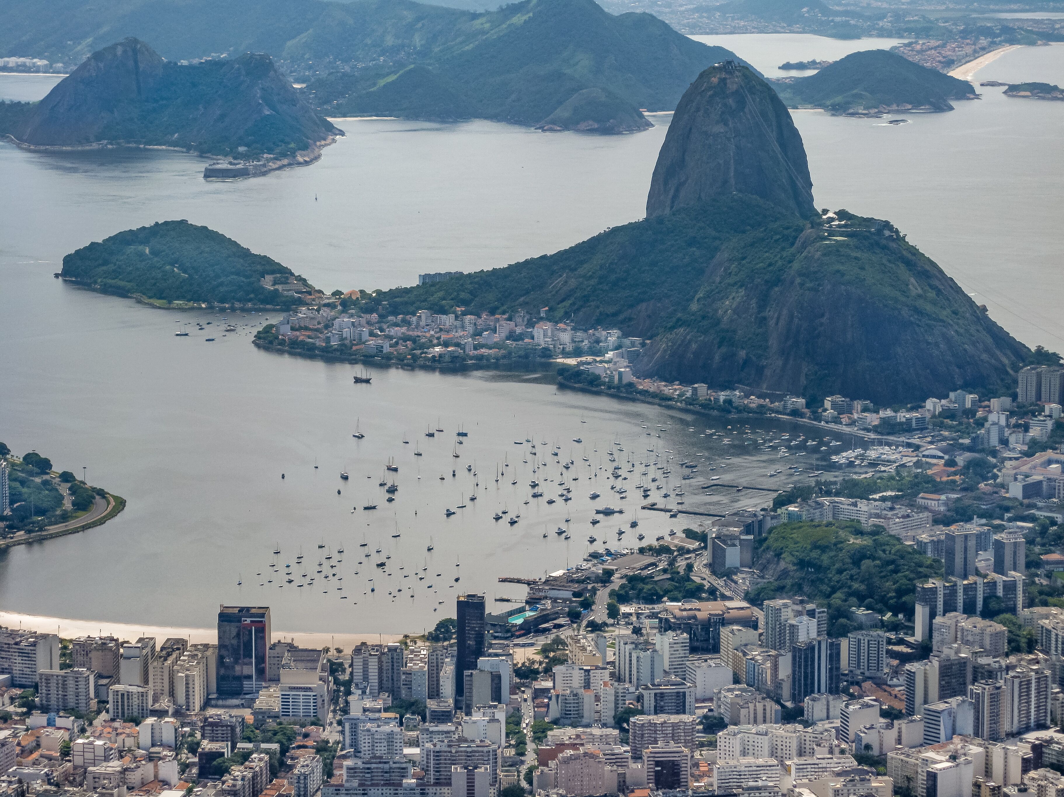 Rio de Janeiro, Brazil - December 24, 2008: Aerial view on Sugarloaf mountain and the entrance to bay with Praia da Urca, and Botafogo neighborhoods. Tall buildings and Santa Cruz fortification.