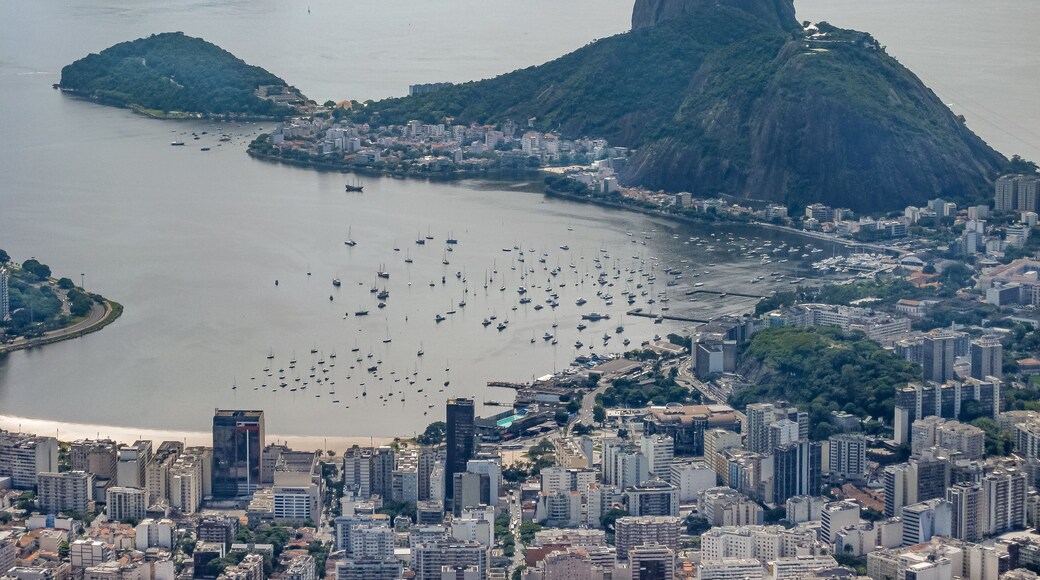 Rio de Janeiro, Brazil - December 24, 2008: Aerial view on Sugarloaf mountain and the entrance to bay with Praia da Urca, and Botafogo neighborhoods. Tall buildings and Santa Cruz fortification.