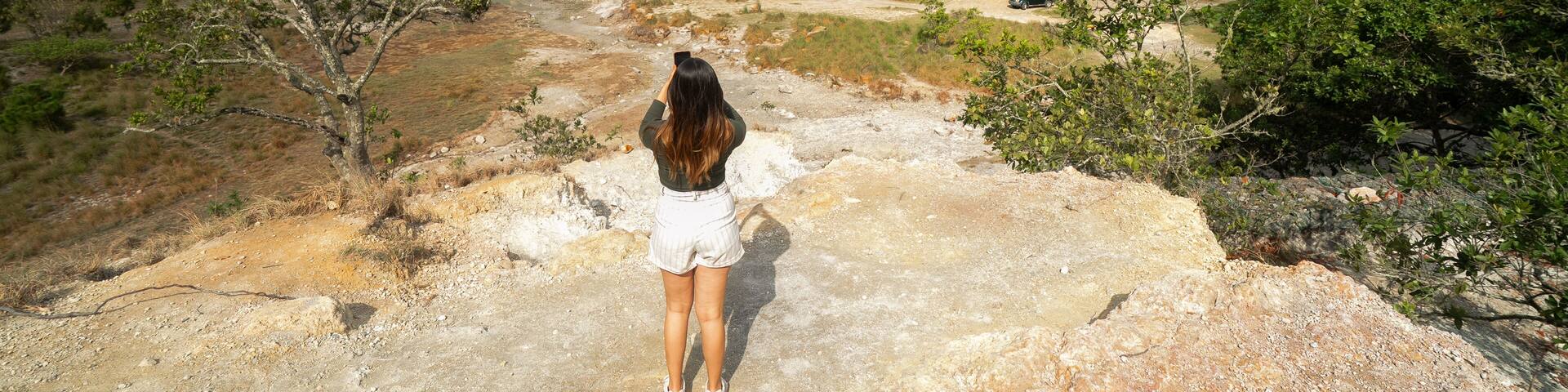 Latin Girl looking a sulfur-rich crater lake located in Alegría, Usulután, El Salvador. Its vibrant greenish color and volcanic origins create a striking natural landscape