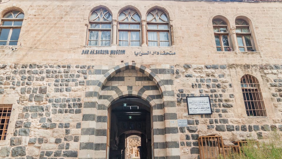 The Dar As-Sarra Museum with stone architecture and arched windows.