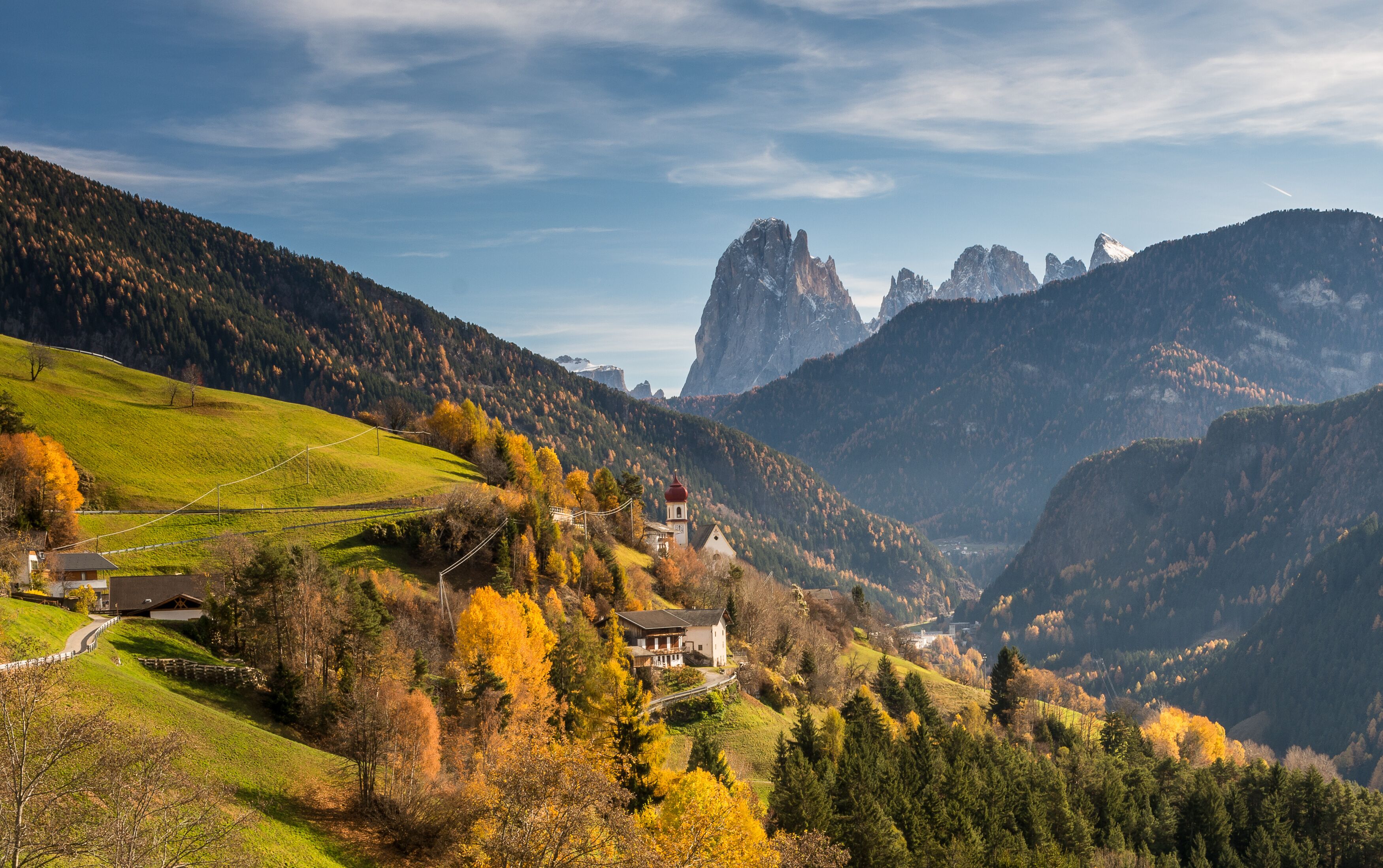 San Pietro di Laion is located at 1,210 m asl above the road from Chiusa to Ortisei The Baroque bulbous spire is the symbol of the village, located high above the Valgardena valley.
