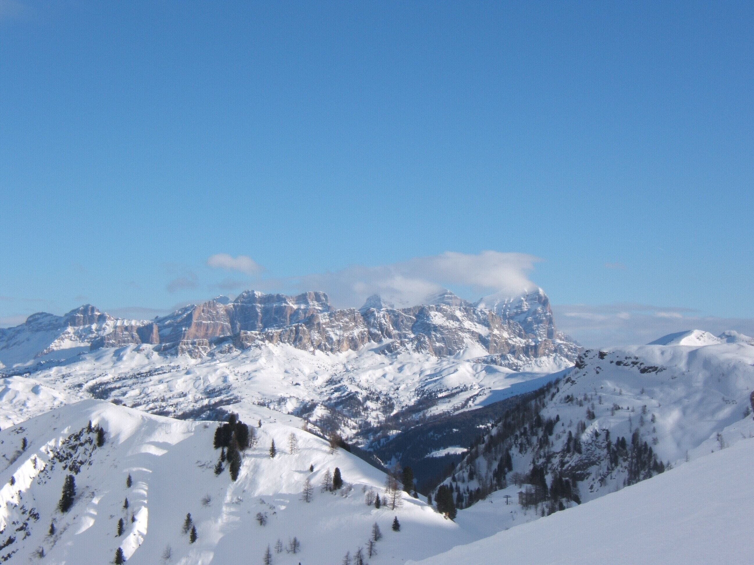 A snow-covered mountain range with clear blue skies.