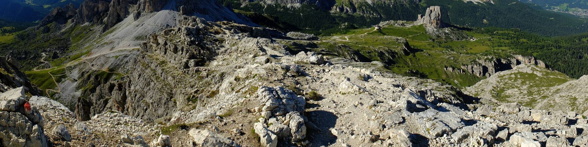 A mountainous landscape with rugged peaks and a winding path.