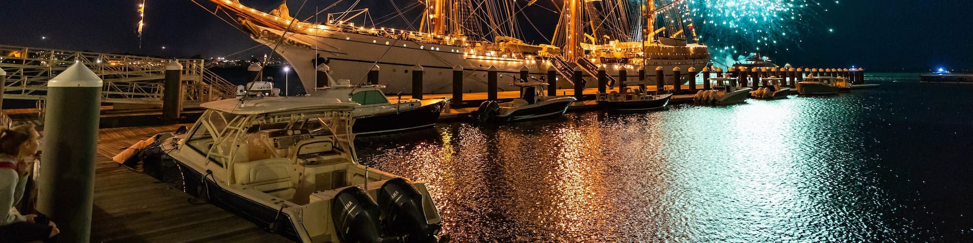 Seaport District featuring heritage elements, a bay or harbor and night scenes