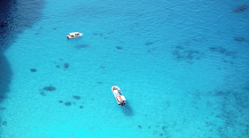 Lonely boats casting a shadow in the deep turquoise water of Navagio Beach (Ναυάγιο) #LifeAtExpedia #SeasideDiscoveries