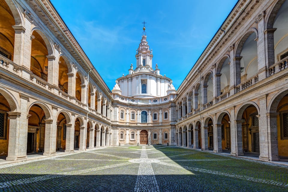 A courtyard with a central dome and arches.