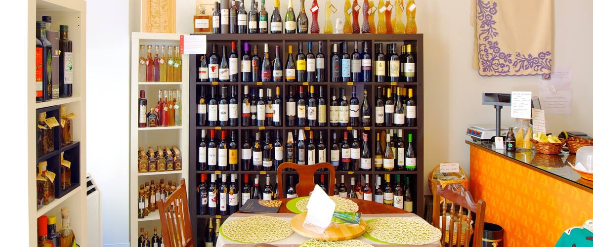 A wine shop with shelves of wine bottles and a table with a placemat.