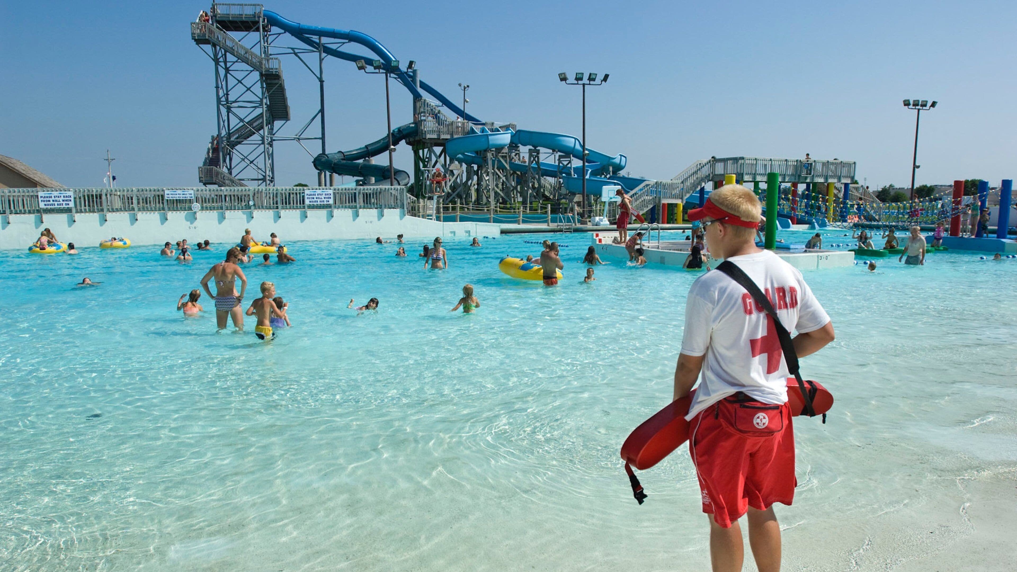 Island Oasis Water Park featuring swimming and a waterpark as well as a small group of people