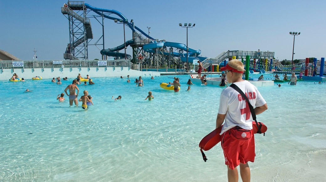 Island Oasis Water Park featuring swimming and a waterpark as well as a small group of people