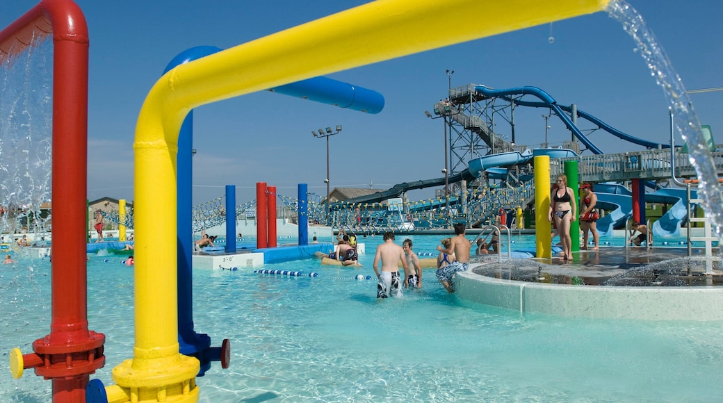 Island Oasis Water Park showing swimming and a waterpark as well as a small group of people