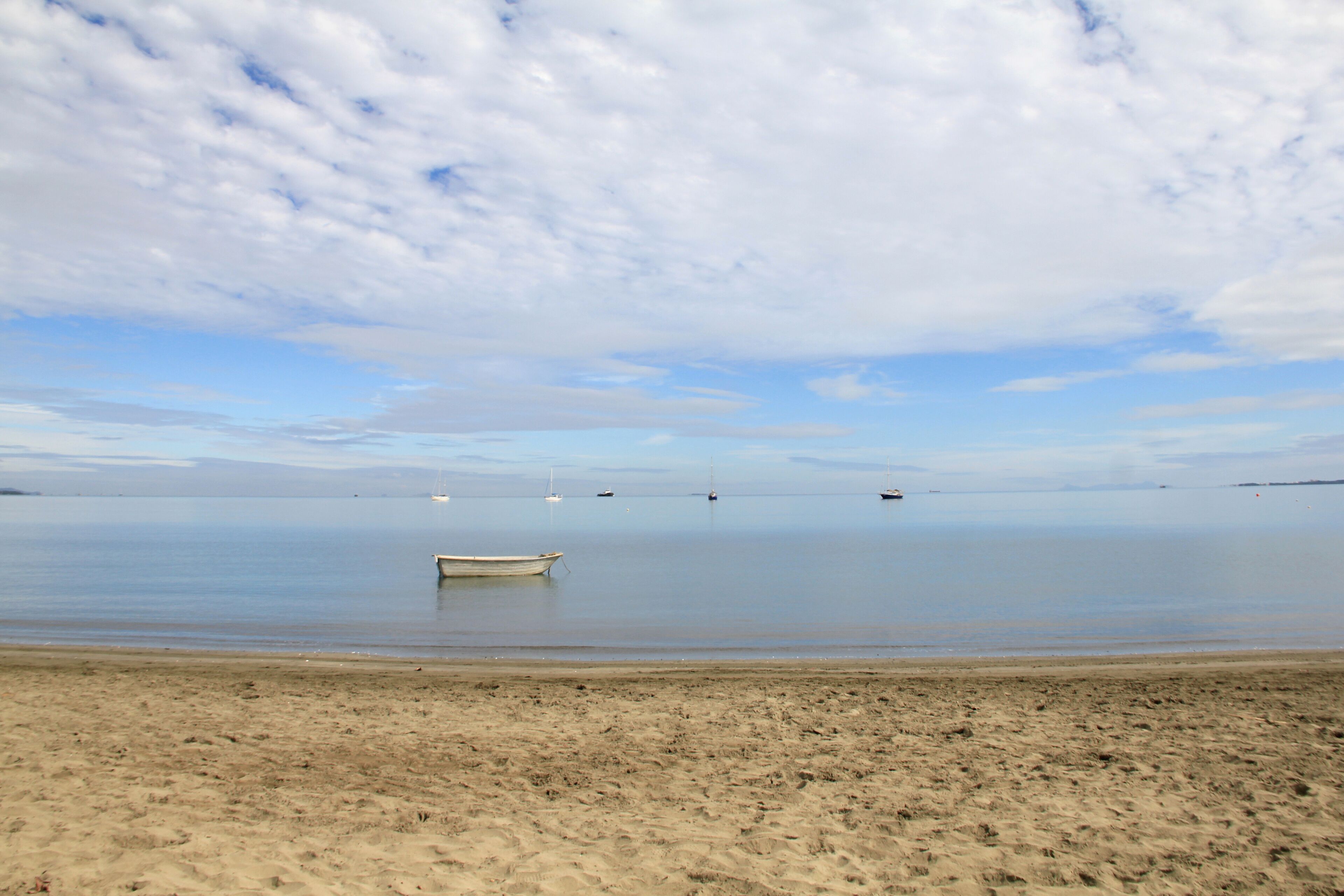 Beautiful cloudy day at Wailoaloa beach, Fiji. Nice beach,with clean water, sand is naturally dark giving the impression of dark water. 