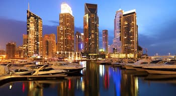 Dubai Marina which includes night scenes, boating and cbd